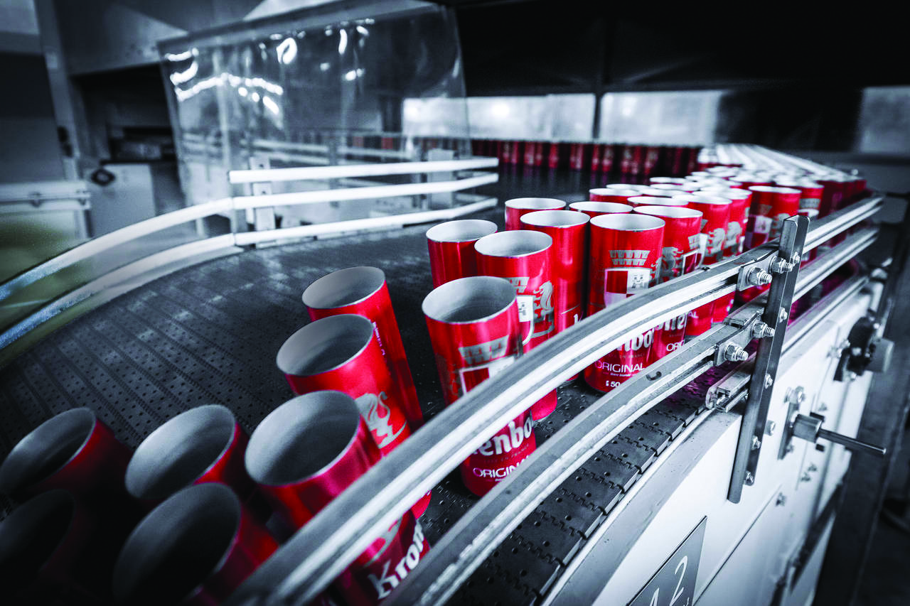 Image of cans moving on a conveyor belt